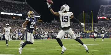 Dynamic shot of an NFL receiver making a spectacular one-handed catch in the 2024 season.