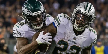 Expert Analysis: Top NFL 2024 Defensive Highlight Revealed NFL defensive player making a crucial, game-changing tackle in a packed stadium.