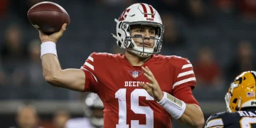 NFL quarterback displaying intense focus during a game-winning play in 2024.