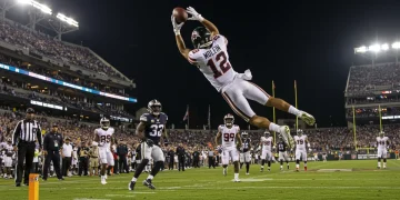 Dynamic shot of a receiver making an unexpected, acrobatic catch in NFL Week 10