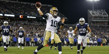 Quarterback throwing game-winning touchdown pass in 2026 NFL mid-season game.