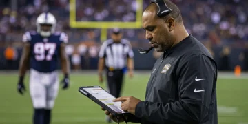 NFL coach analyzing game footage on tablet sidelines 2026 season