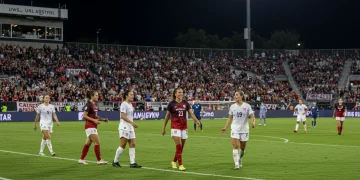 NWSL stadium filled with cheering fans, celebrating women's soccer growth
